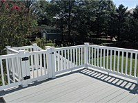 <b>TimberTech Terrain Stone Ash Deck Boards with White Washington Vinyl Railing and gate at the top of the stairs in Hyattsville MD</b>